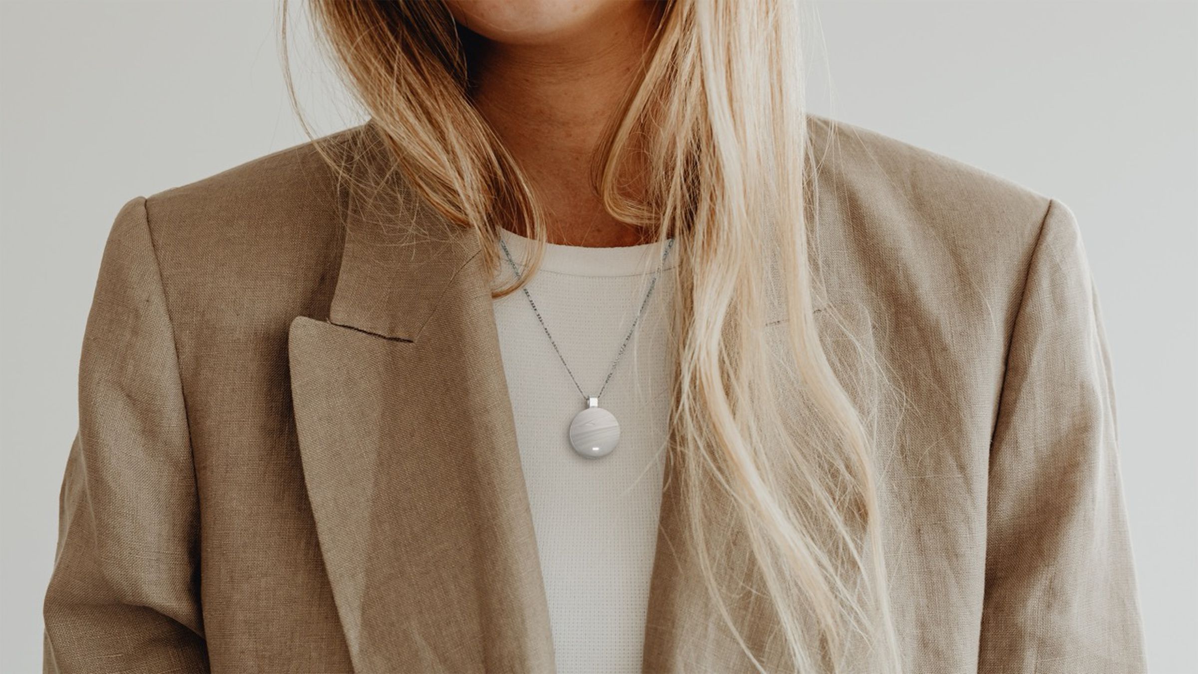 A woman with a glowing wearable around her neck.